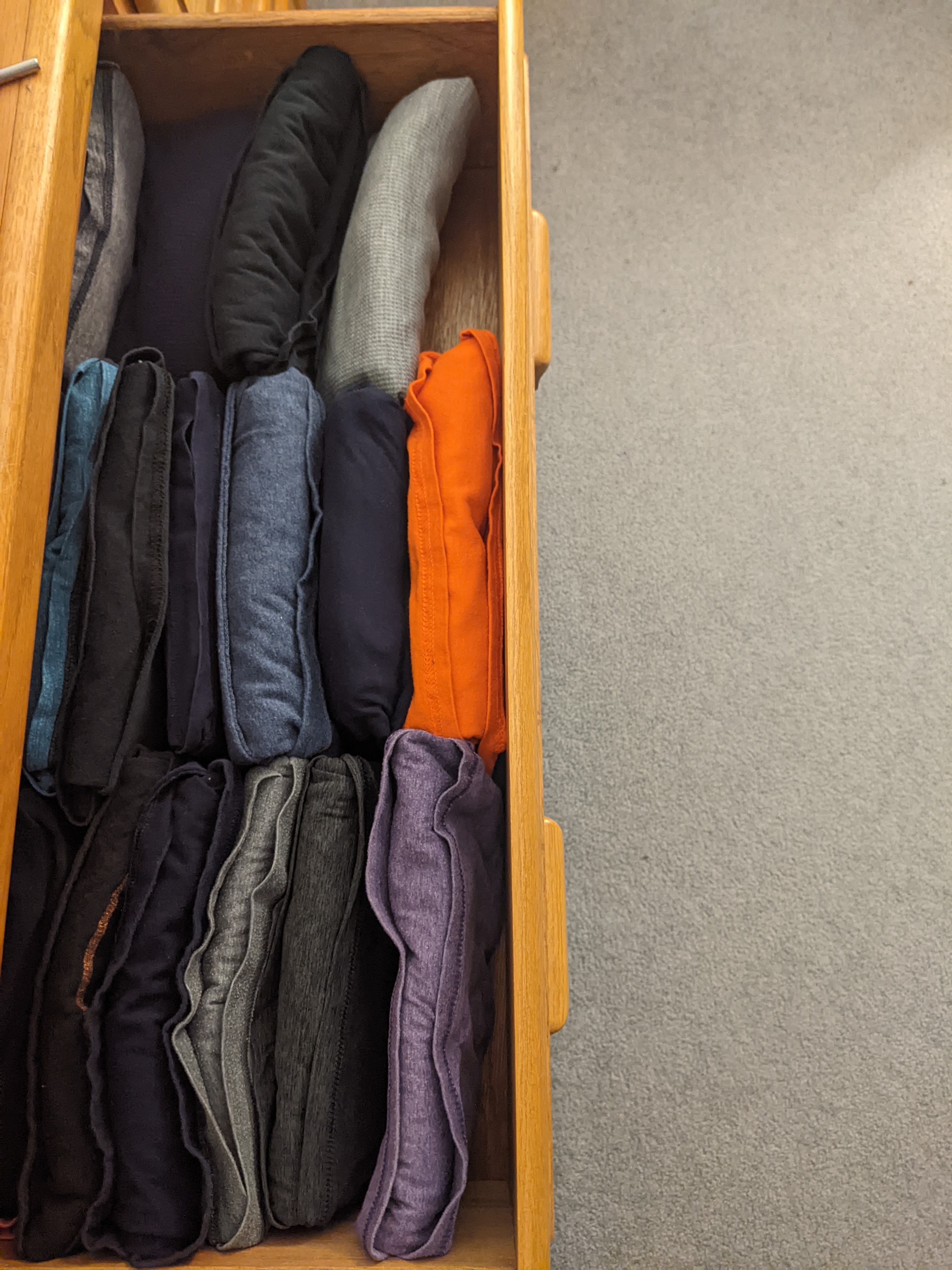 A drawer full of shirts that have been folded using the IRENE method.